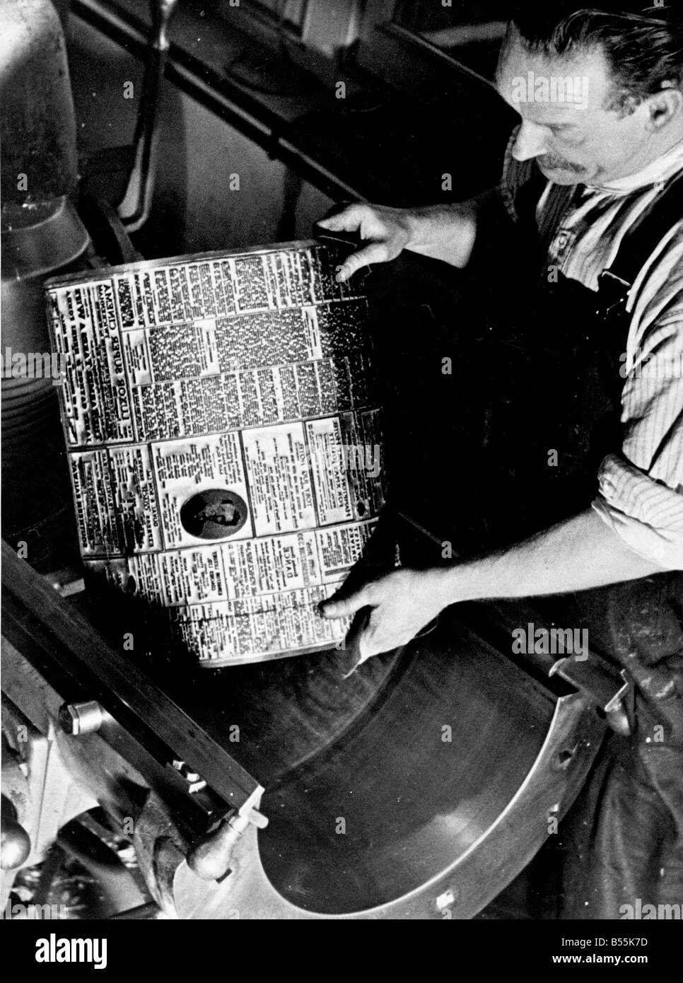 Drucker Circa 1950 &#13; &#10; Drucker legt eine heiße Metallplatte auf einer Druckmaschine &#13; &#10; P044517 Stockfoto