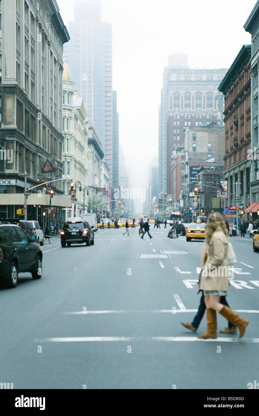 Fußgänger überqueren Straße in Zebrastreifen bei W 19th Street und 6th Avenue, Chelsea, New York, nach NE Stockfoto