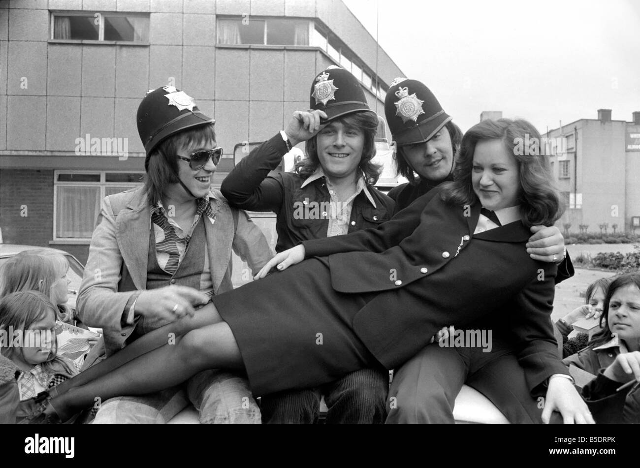 Pop-Gruppe "Schlamm". mit Polizisten, wie sie Pilce Helme tragen &#13; &#10; Mai 1975 Stockfoto