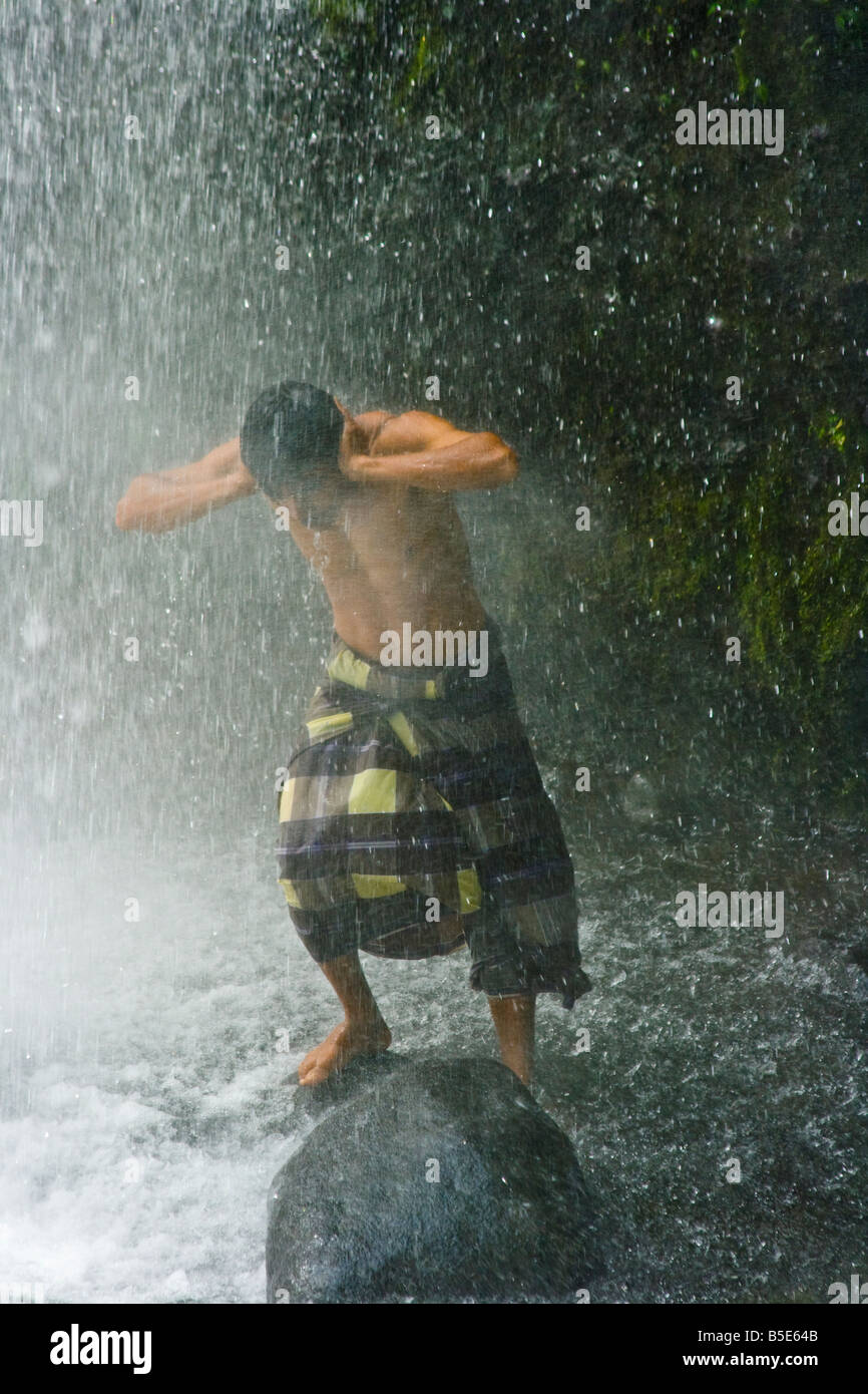 Lokale Mann unter Sindang Gila Wasserfall in Senaru auf der Insel Lombok in Indonesien Stockfoto