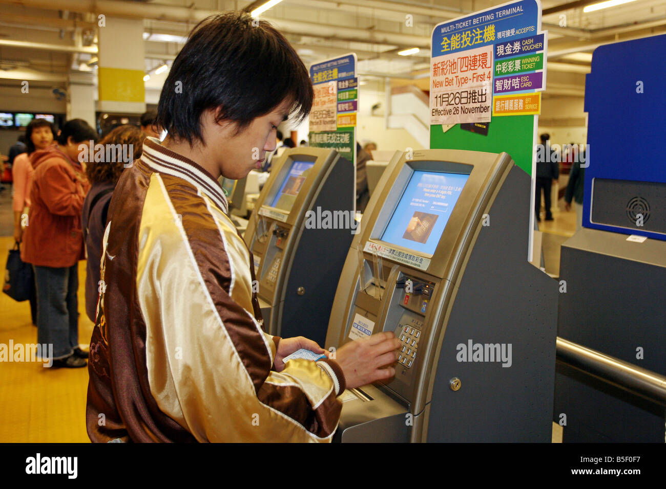 Man Wetten für ein Horce Rennen auf der Strecke von Sha Tin, Hong Kong, China Stockfoto