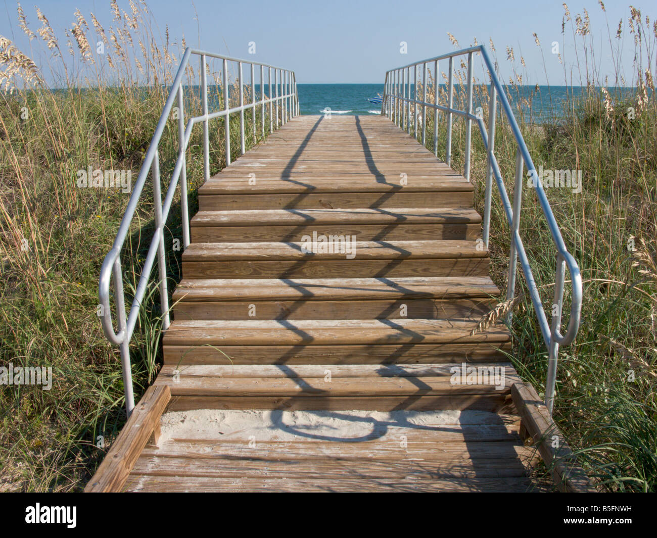 Eine Holztreppe und Promenade führt über die Sanddünen zum Hauptstrand in Myrtle Beach State Park in South Carolina. Stockfoto
