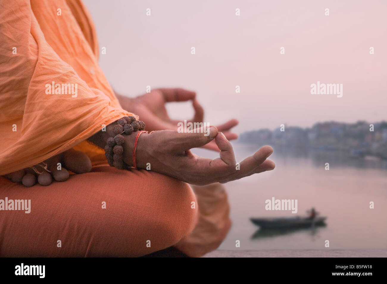 Heiliger Mann meditieren am Ufer Flusses Ganges Varanasi Indien Stockfoto