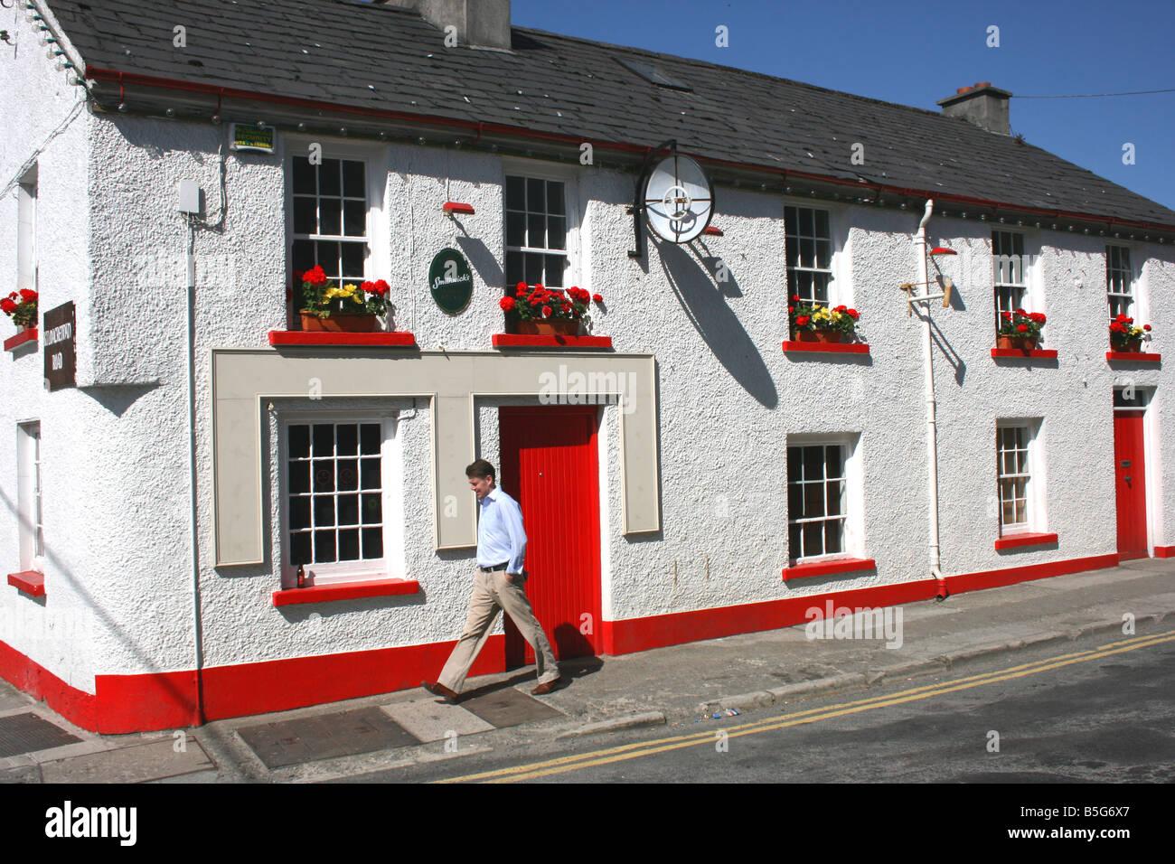 Mann, ein Spaziergang in der Hauptstraße der Stadt Milford, County Donegal, Irland Stockfoto