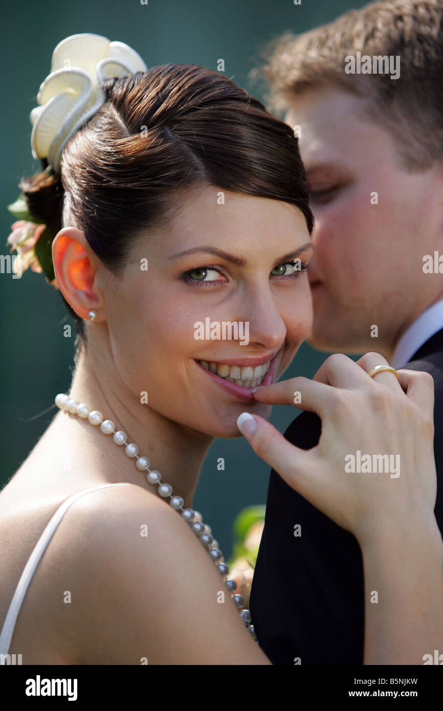 Nahaufnahme eines lächelnden Braut am Tag der Hochzeit stützte sich auf die Schulter des neuen Ehemann Stockfoto