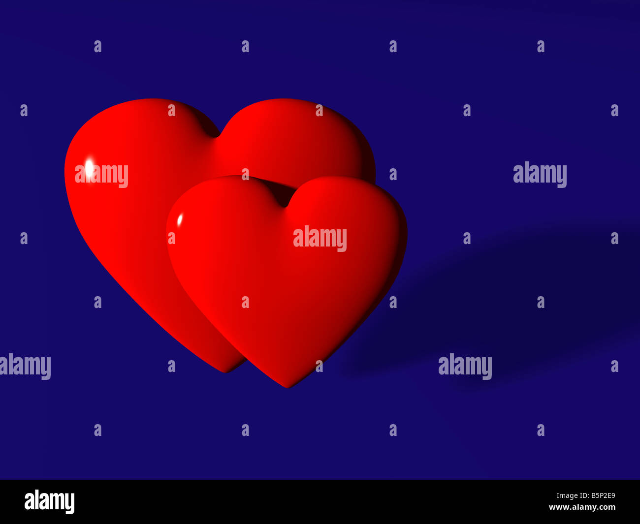 Zwei rote Herzen gegen dunkelblauen Hintergrund. Stockfoto