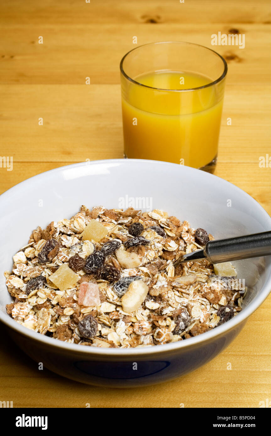 Eine Schüssel Müsli Frühstück und ein Glas Orangensaft Stockfoto