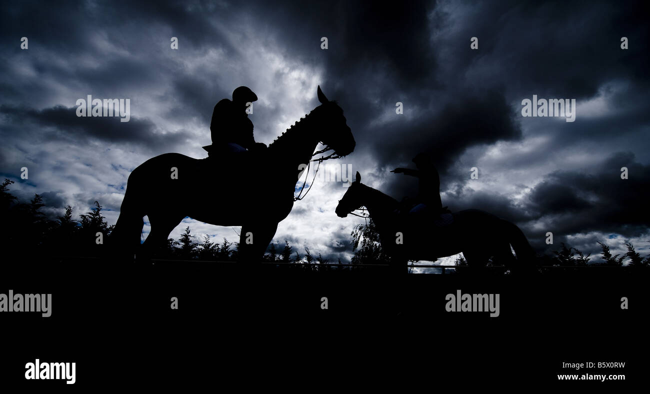 Reiter auf ihren Pferden sind gegen ein bewölkter Himmel während der Toledo CSI Pferd springen Meisterschaft in Zentralspanien Silhouette. Stockfoto