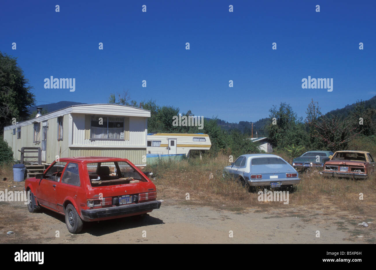 Alte Autos und Wohnwagen bei Hoopa Tal Indianerstamm Reservierung in Kalifornien, USA Stockfoto