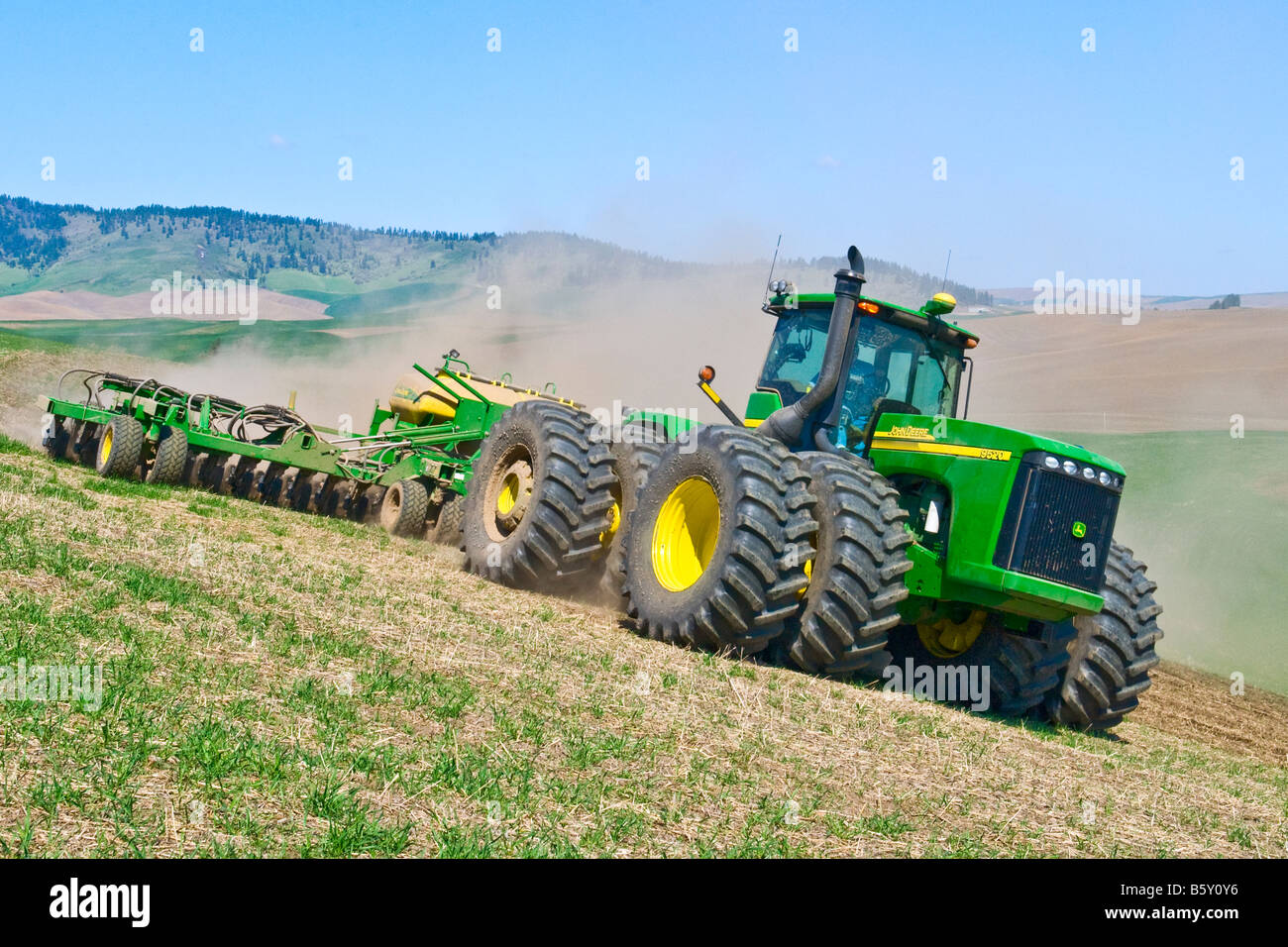 Ein Traktor zieht einen Luft-Sämaschine um Winterweizen beschädigt durch Schnee im Frühjahr in der Palouse Region Washington neu bepflanzen Stockfoto