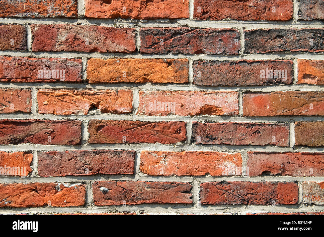 Textur und alte Mauer mit farbigen Steinen Stockfoto