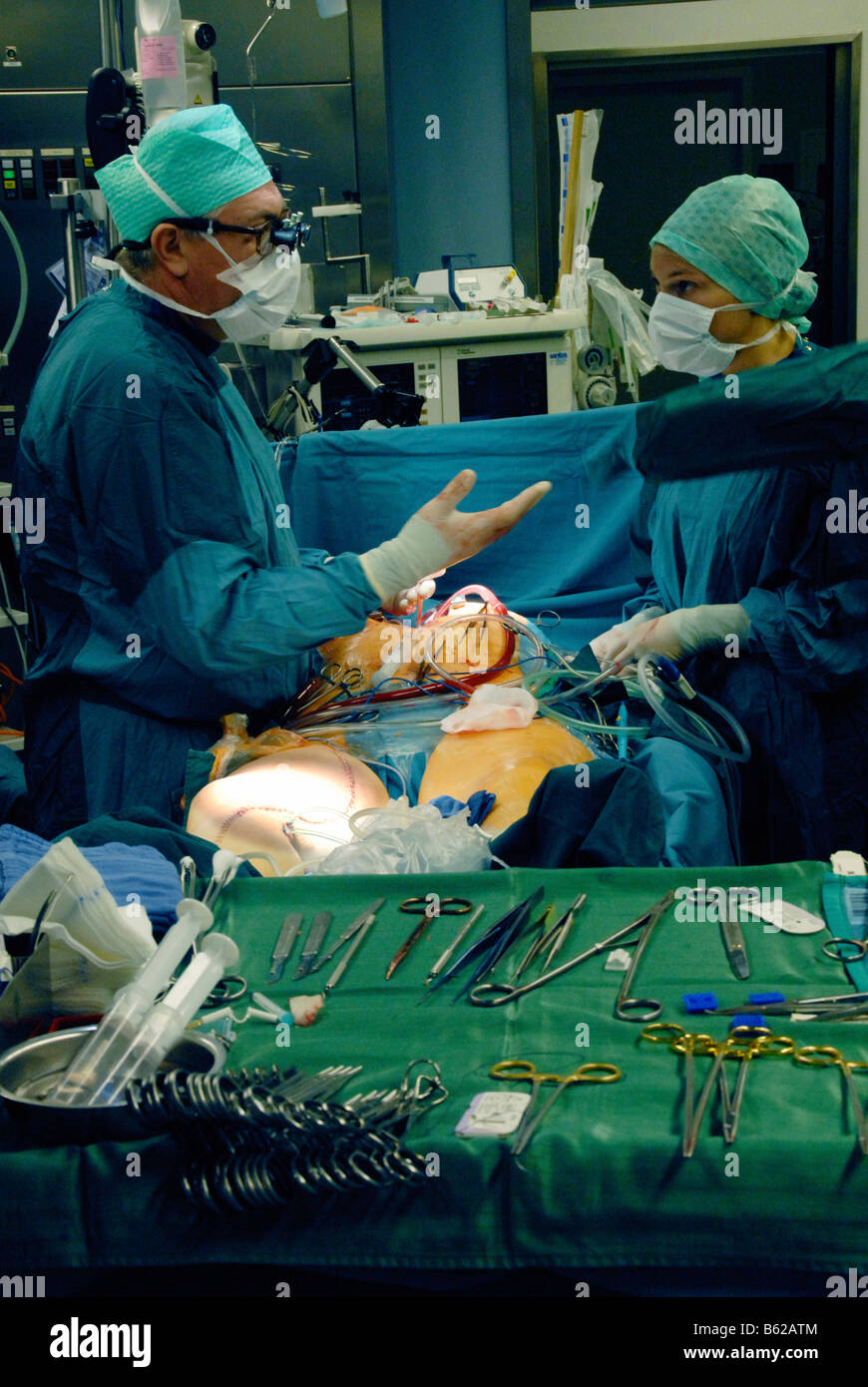 Männliche und weibliche Ärzte während einer Herzoperation Stockfoto