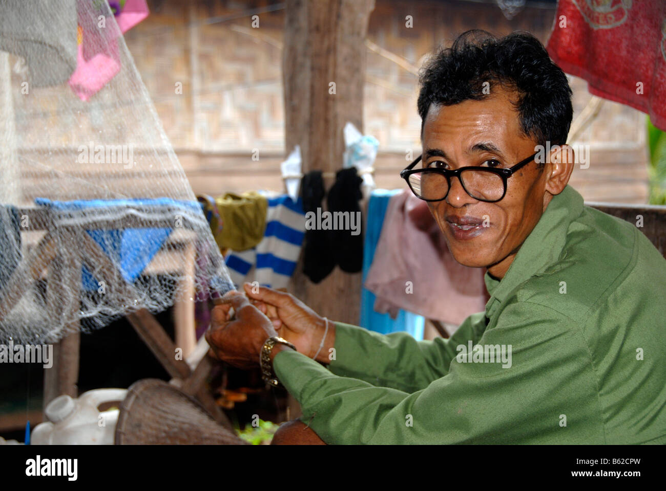 Fischer des Stammes Tai Yang Reparatur ein Netz, Ban Naten, Nam Lan Conservation Area, Provinz Phongsali, Laos, Südostasien Stockfoto