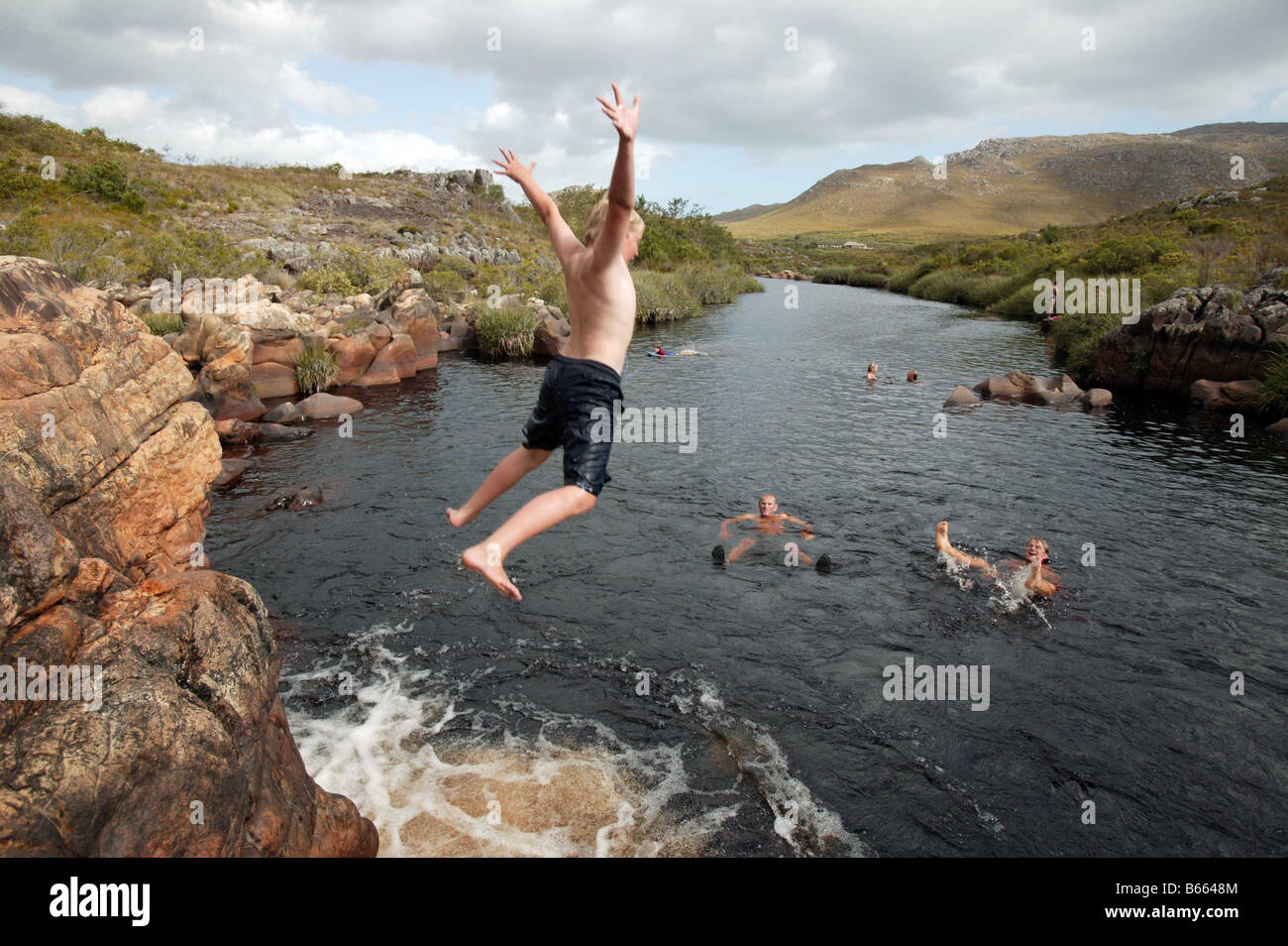 Freunde und Familien springen in Palmiet River, Südafrika Stockfoto