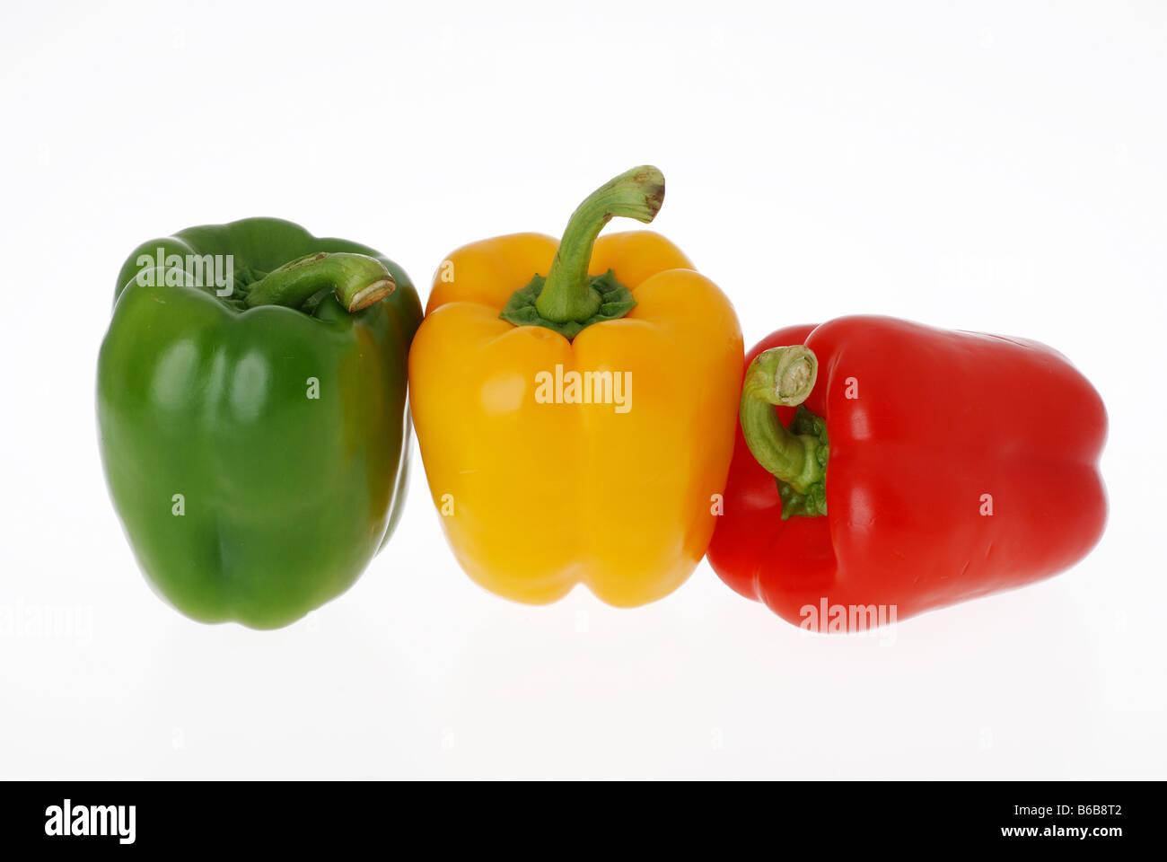 PAPRIKA GELB GRÜN UND ROT AUF WEIßEM HINTERGRUND Stockfoto