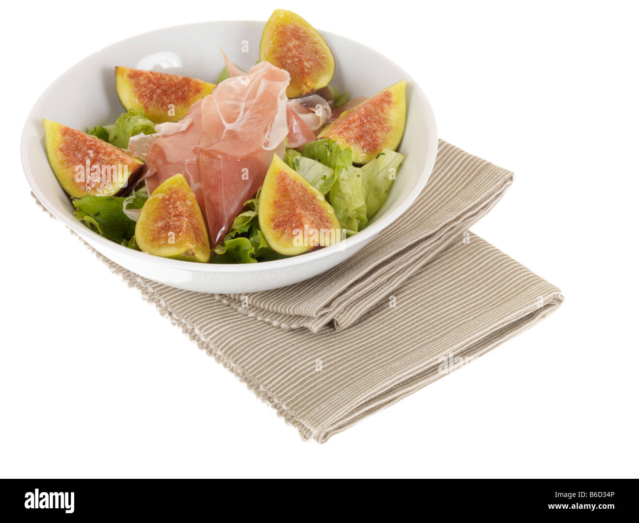 Frische reife Feigen- und italienischen Schinken Salat mit Salat und grünen Salat serviert in einer weißen Schüssel mit Keine Personen Stockfoto