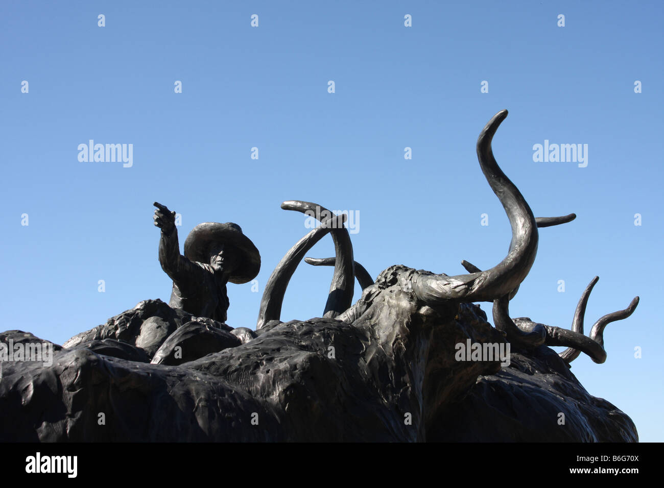 Bronzestatue von Texas Longhorn Rindern wird durch ein Cowboy zu Pferd in der Nähe von Forth Wert Stockyards getrieben Stockfoto