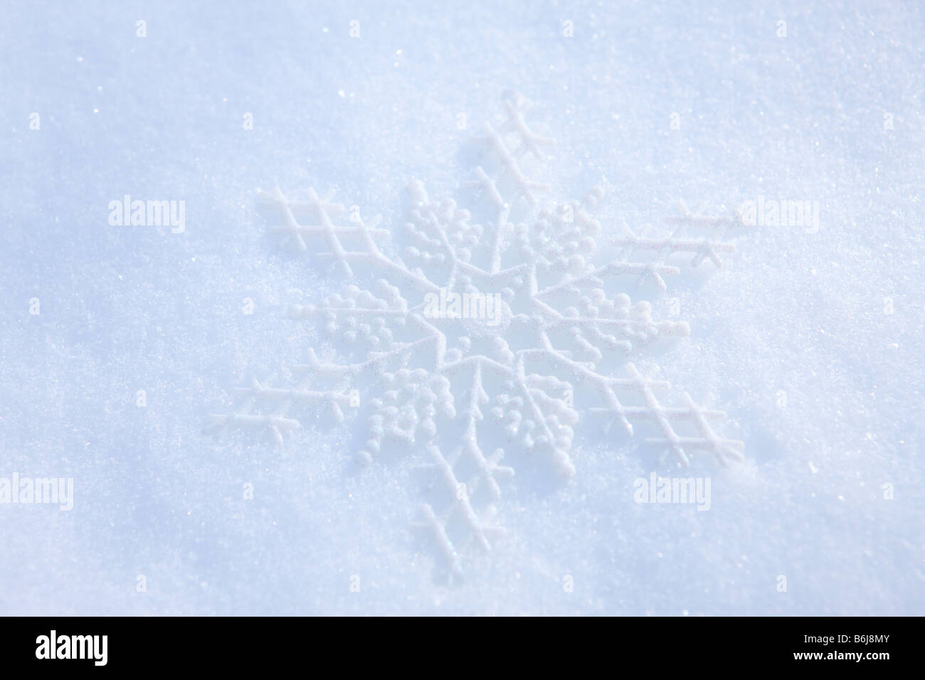 Schneeflocke Ornament Verlegung in frischen weißen Winterschnee Stockfoto