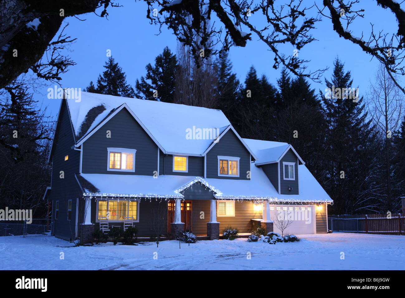 Winter-Haus in der Nacht mit Lichtern auf und Schnee Stockfoto