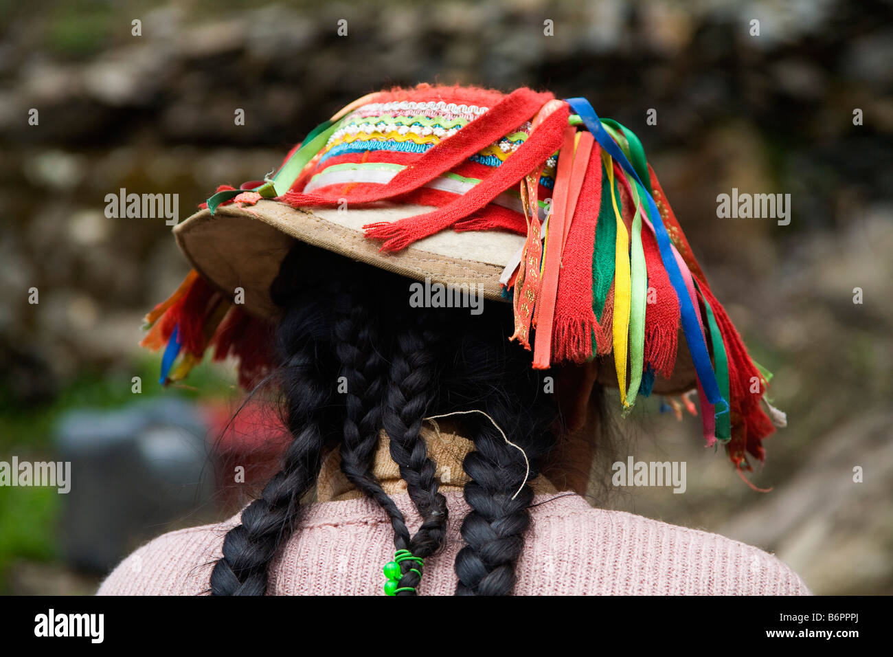 Eine peruanische Frau trägt einen traditionellen Hut hoch in den Anden Perus Stockfoto