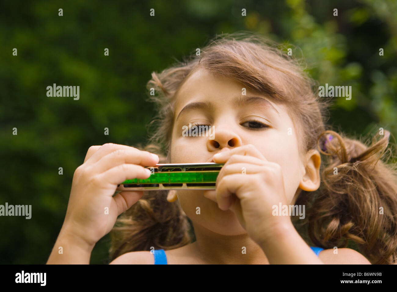 Ein Mädchen, die Mundharmonika spielen Stockfoto