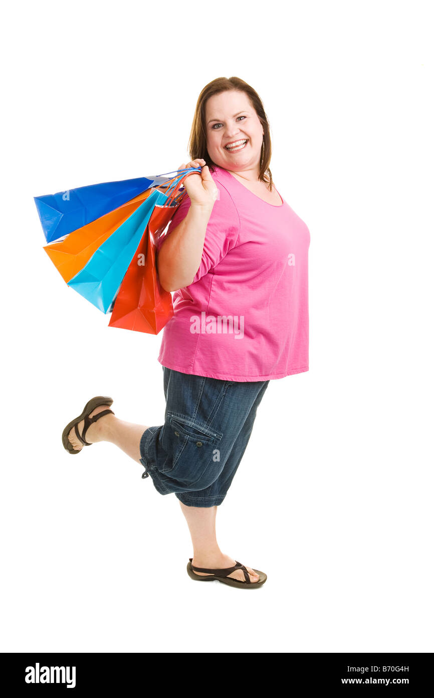 Glückliche begeisterte plus Größe Frau auf einem shopping trip Ganzkörper isoliert auf weiss Stockfoto Glückliche begeisterte plus Größe Frau auf einem shopping trip Ganzkörper isoliert auf weiss Stockfoto