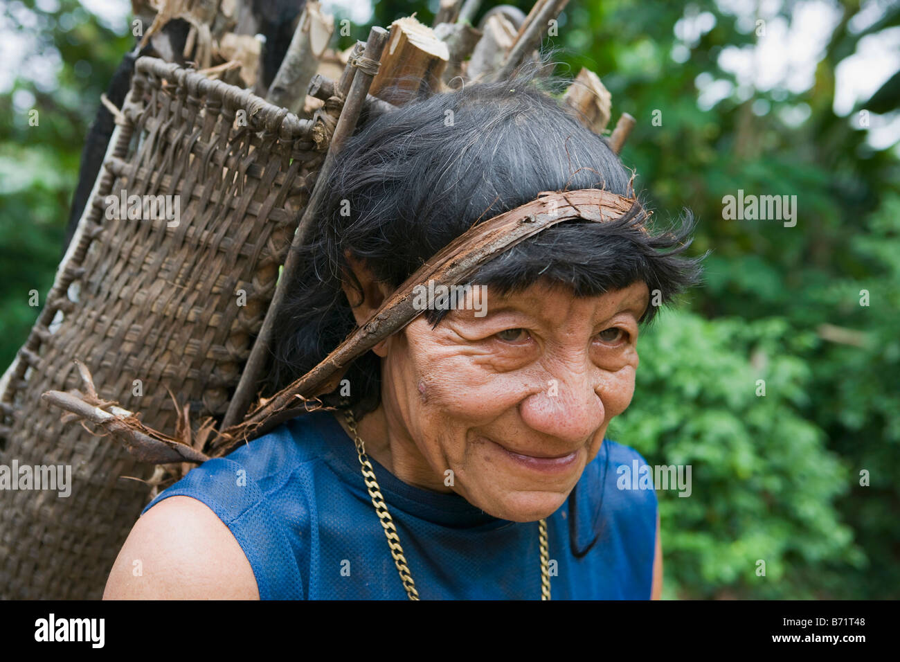 Suriname, Kwamalasamutu, Heimat der eingeborenen Indianer. Akurio indischen Mann mit Brennholz. Stockfoto