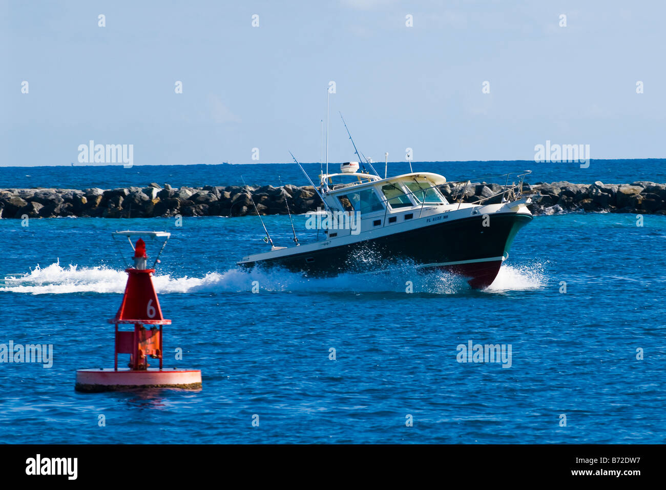 Palm Beach Shores, kleines privates Freizeitspiel Angeln Schnellmotorboot, das vom Meer zum Yachthafen zurückkehrt, mit Markierungsboje, tiefblauem Meer und Himmel Stockfoto