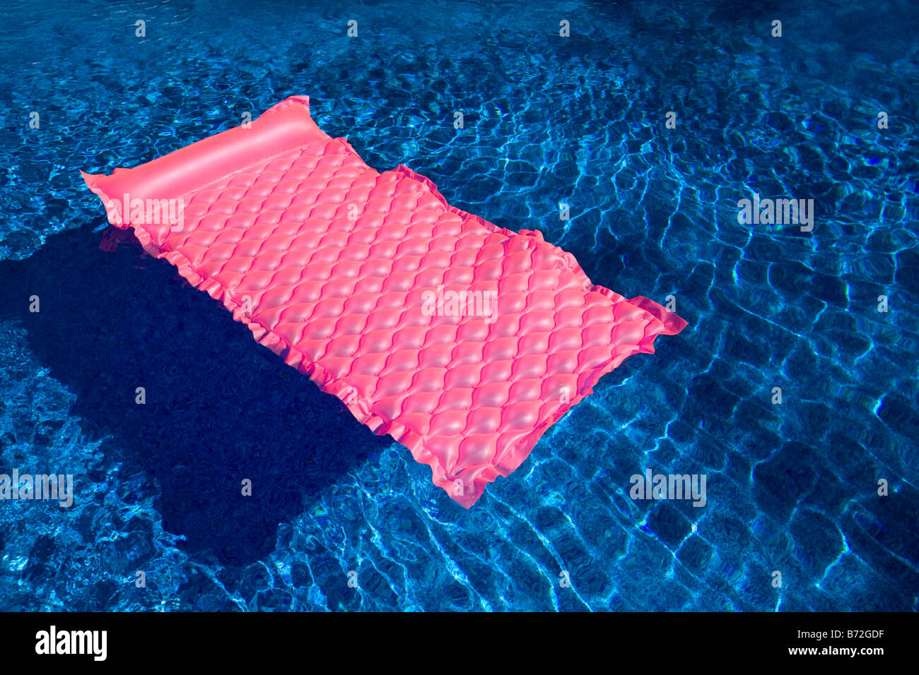 Eine aufblasbare Wasser-Matte schwimmt auf dem Wasser in einem Schwimmbad. Stockfoto