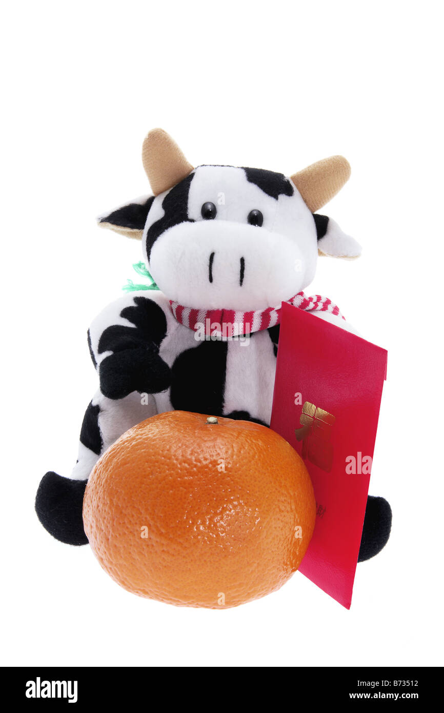 Plüschtier Kuh und Mandarin Stockfoto