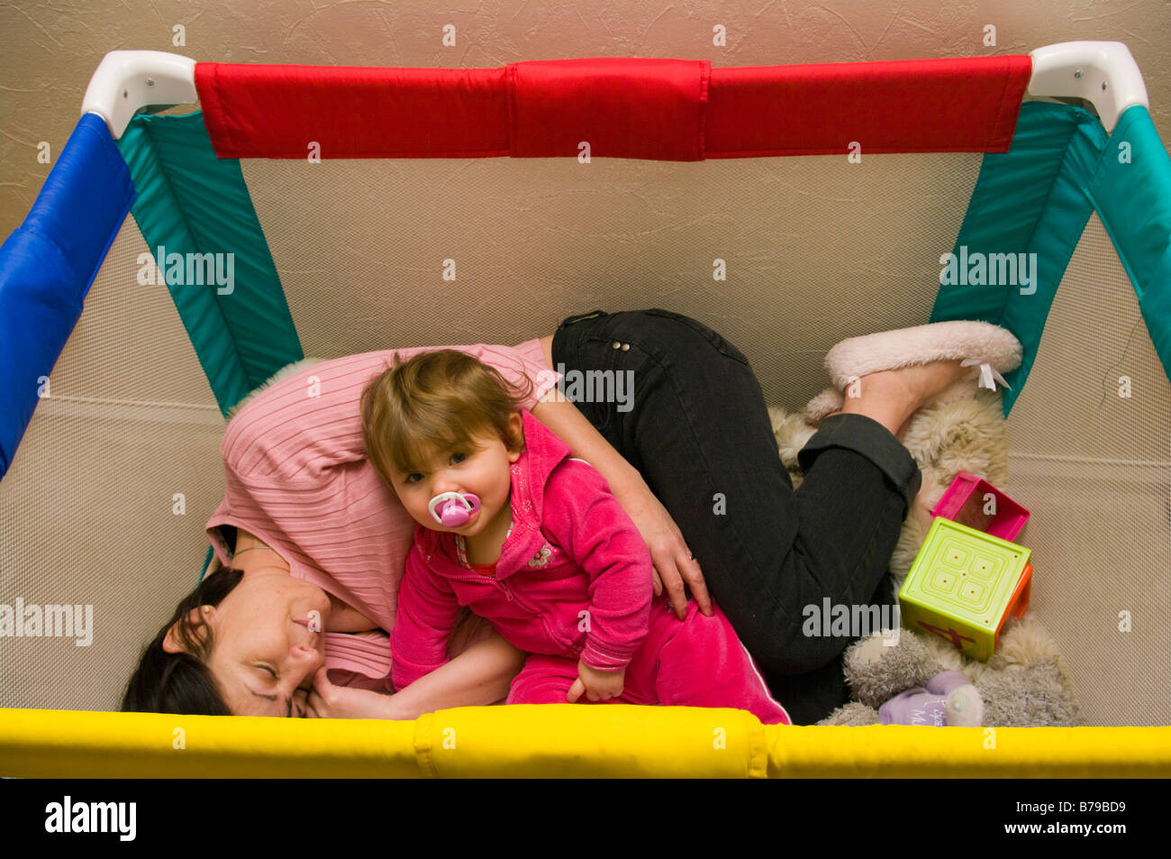 Mutter Eltern verbindet Baby im Laufstall zu Versuchen, Sie zu schlafen Stockfoto
