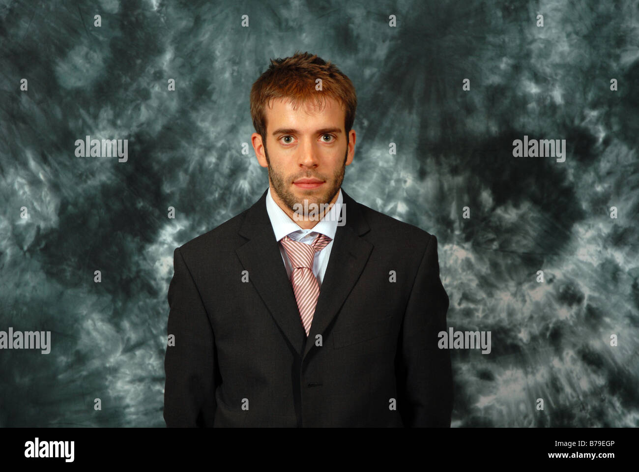 Porträt eines intelligenten jungen Mannes vor einem grauen Hintergrund Stockfoto