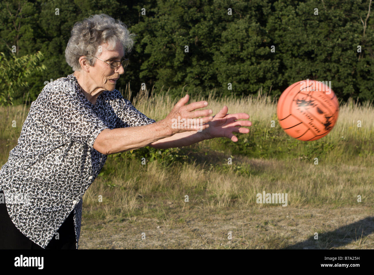 alte Frau durch das Spiel mit ball Stockfoto