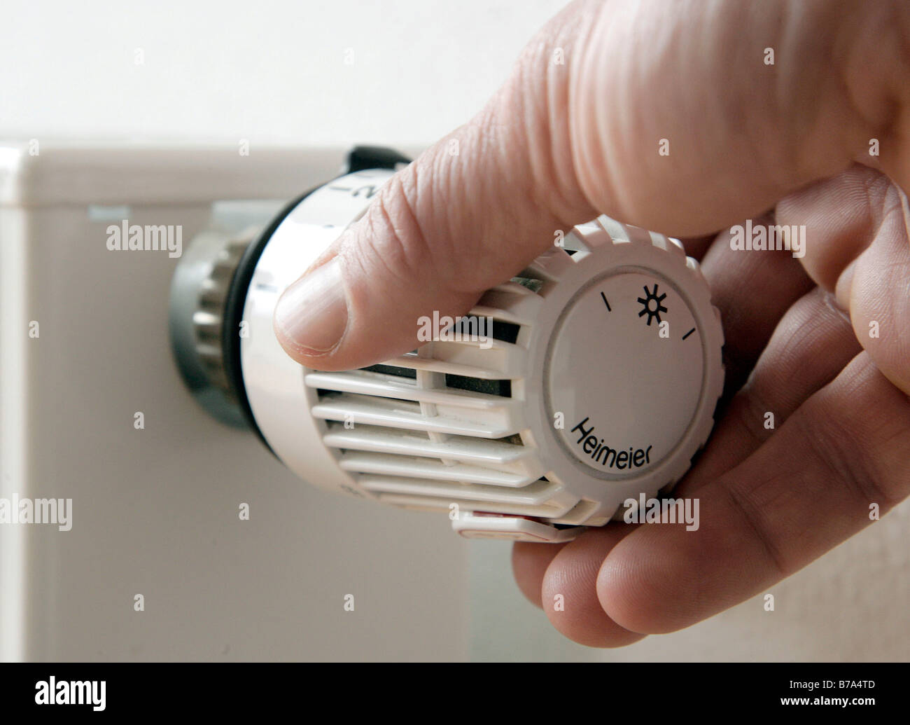 Hand dreht an Heizungsthermostat - ein lizenzfreies Stock Foto von Photocase