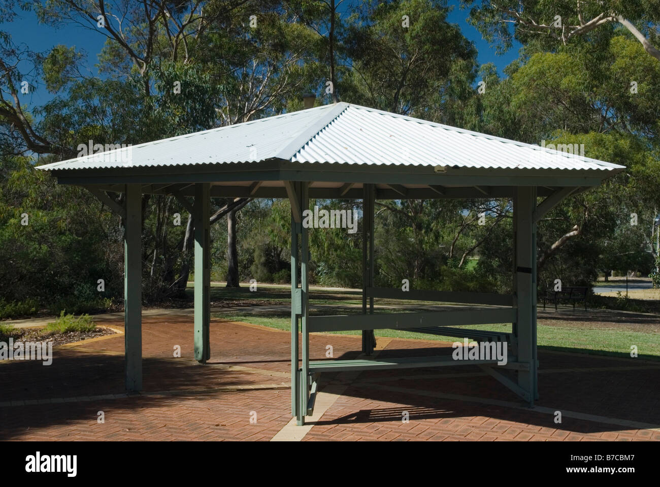 6 seitig Pavillon Schatten struktur mit Wellblechdach in einem kleinen Park umgeben von Bäumen Stockfoto