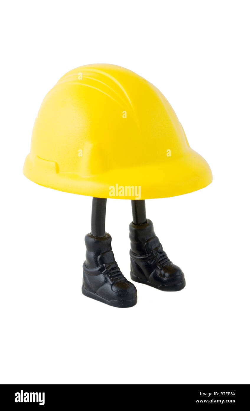 Ein Plastikmodell einen großen gelben Schutzhelm mit zwei dünnen Stock Beinchen mit schwarzen Stiefeln, die unterstützenden it- Stockfoto