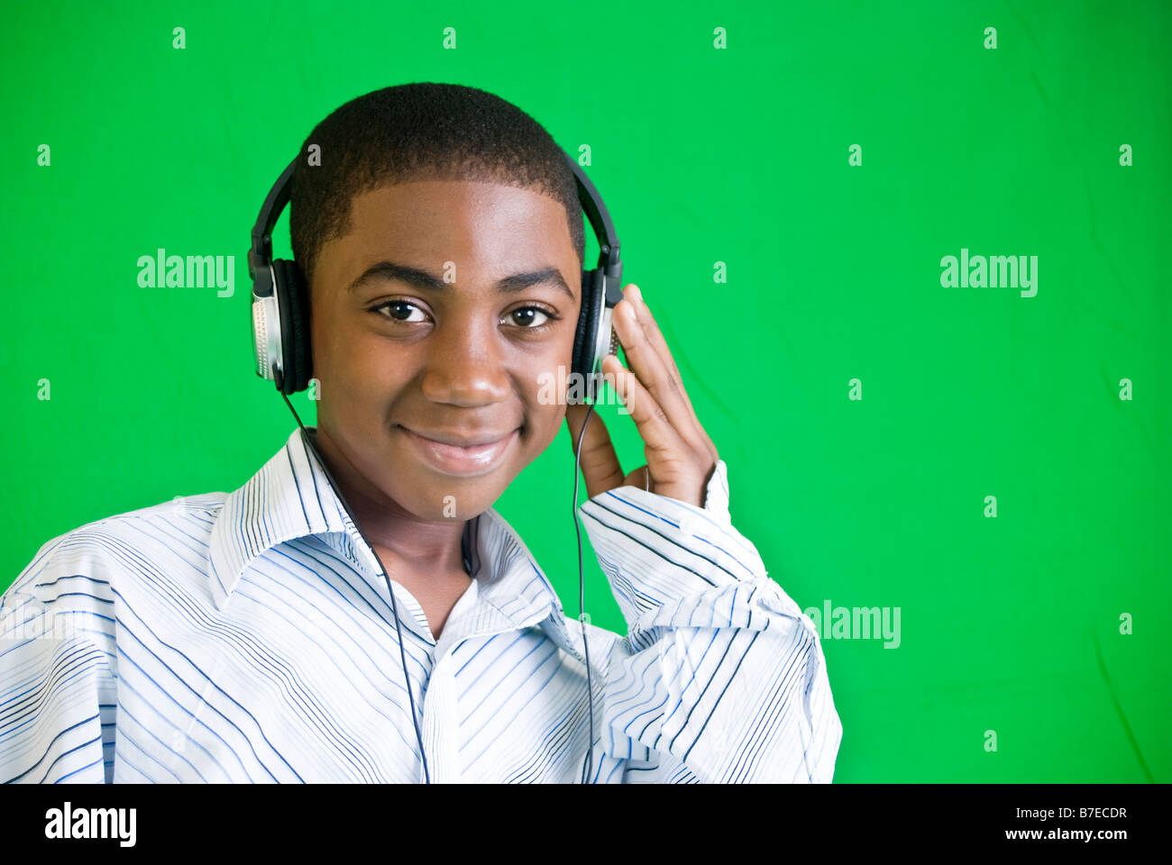Ein afroamerikanischer junge tragen von Kopfhörern und lächelnd Stockfoto