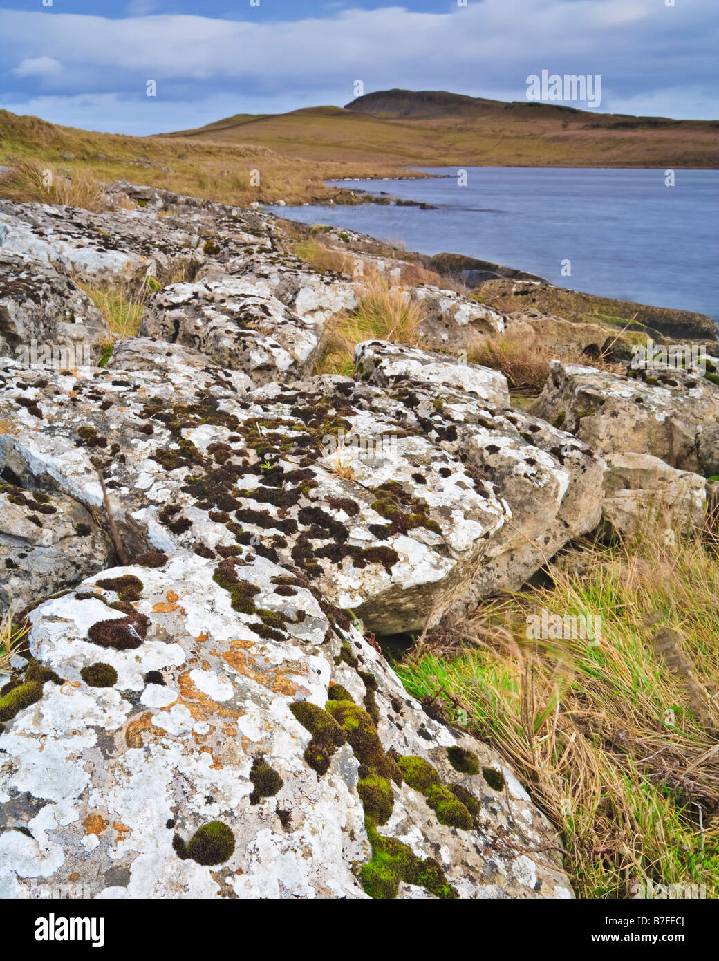 Die gebrochenen Felsen ein Kalkstein Pflaster am Ufer des Broomlee Lough im Northumberland National Park, England Stockfoto