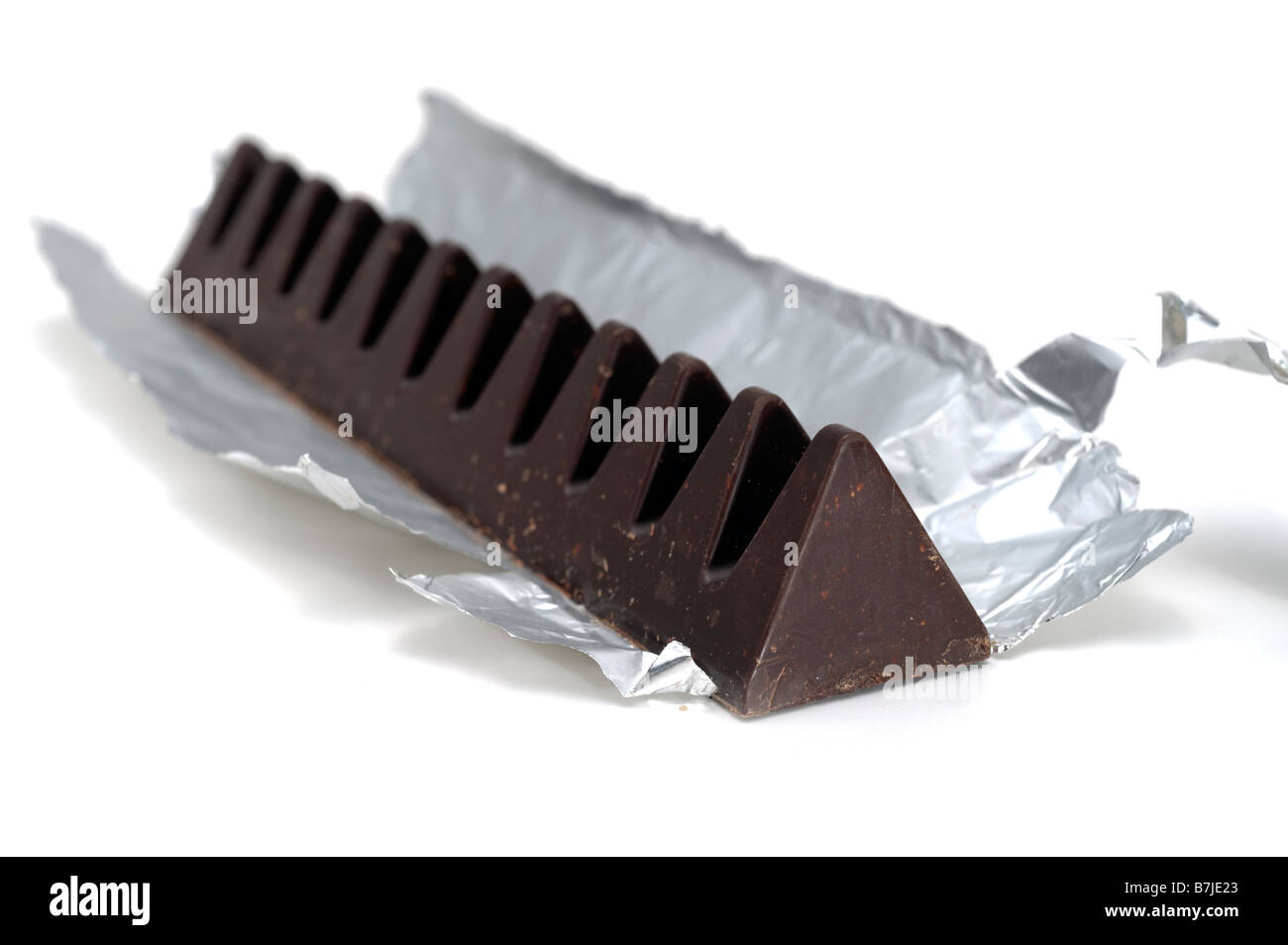 Dreieckig geformte dunkle Schokolade in Silberfolie Stockfoto
