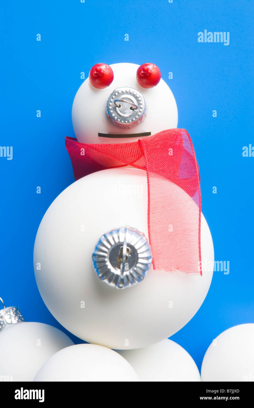 Schneemann aus Weihnachtsschmuck vor blauem Hintergrund gemacht Stockfoto