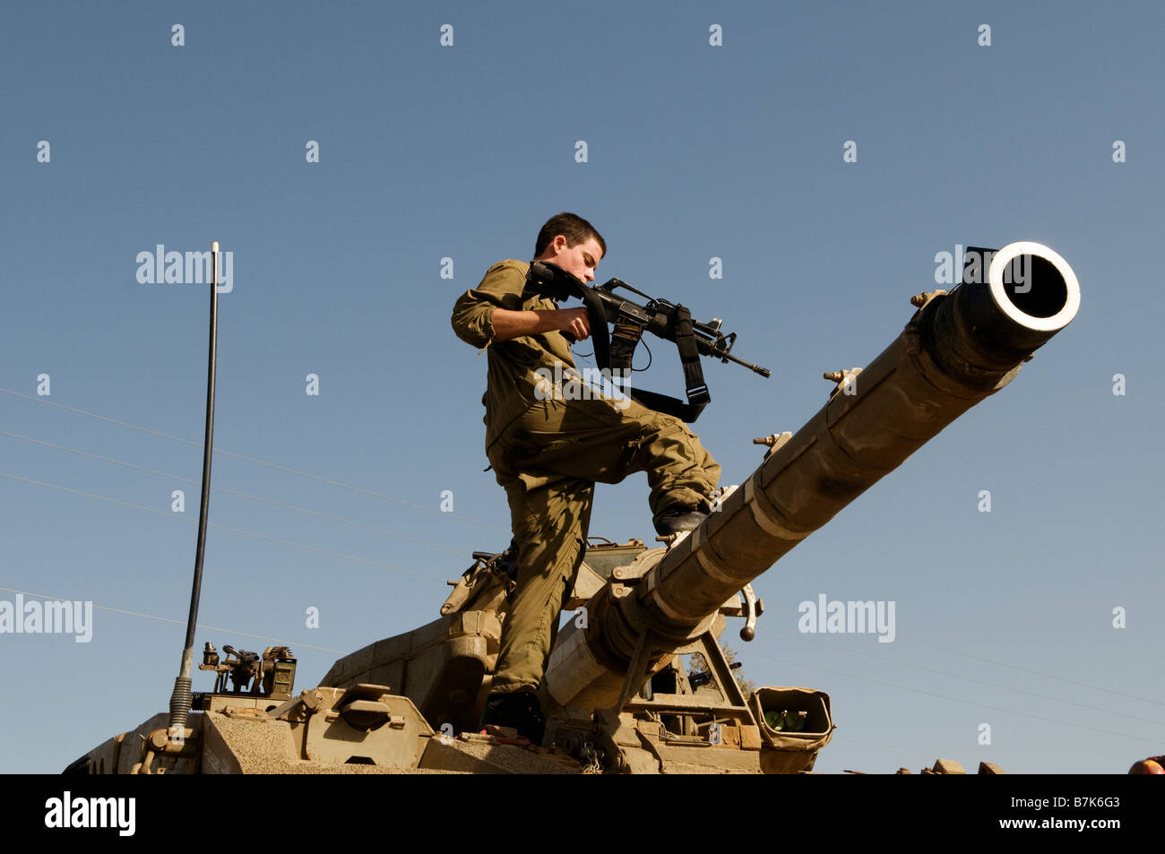 Ein israelischer Soldat Spaziergänge auf der Oberseite eines gepanzerten Tank in Israel. Stockfoto