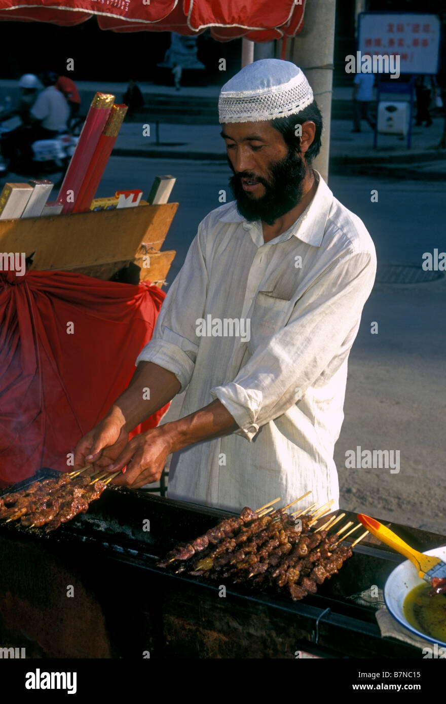 1, 1, Chinesen, muslimischen Mann, Straßenhändler, essen Hersteller, Lebensmittel Verkäufer, Verkauf, Kebabs, Stadt Kunming, Kunming, Provinz Yunnan, China Stockfoto