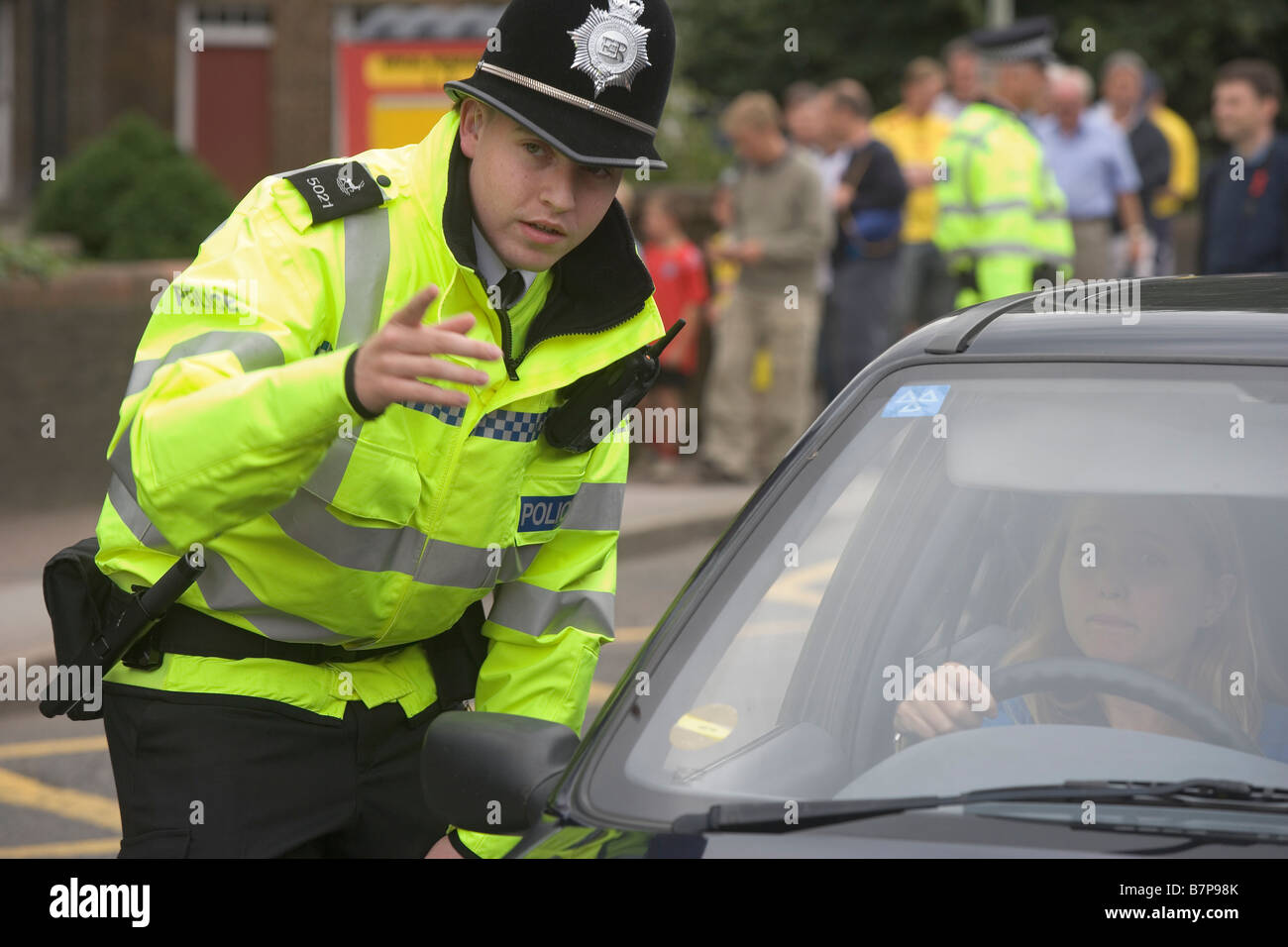 Polizeibeamter spricht einen Treiber beim diensthabenden Verkehr als Unterstützer für das Spiel bei Watford Stadium kommen Stockfoto