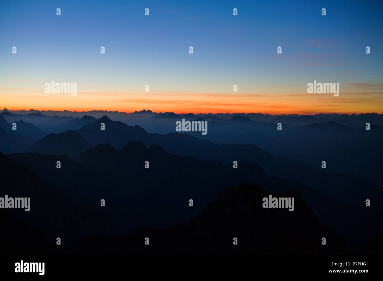 Julischen Alpen gesehen von Mangrt in Slowenien dunklen Bergen in Vordergrund mit reichen orange Sonnenuntergang zum Horizont und vor Stockfoto