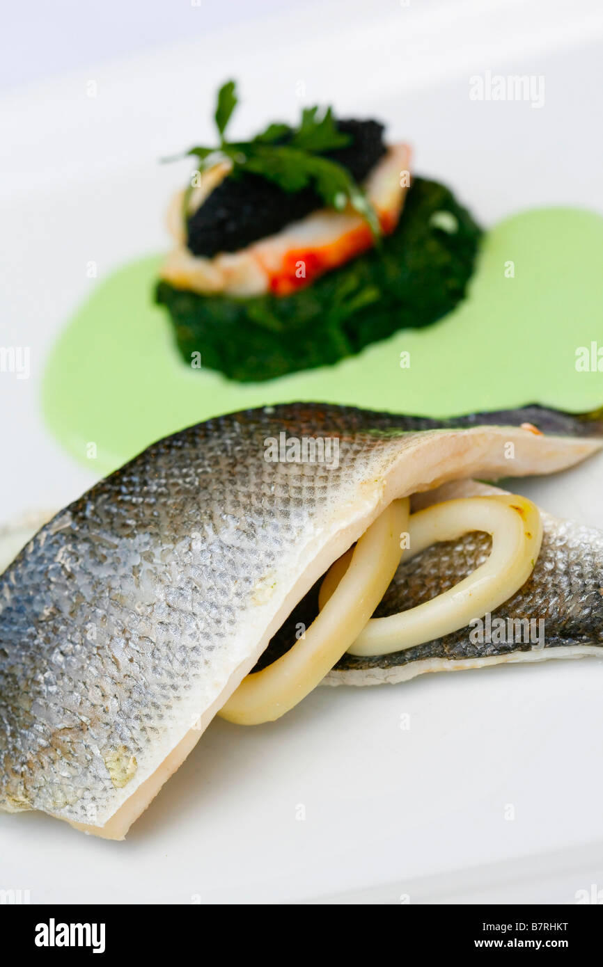 Filet vom Wolfsbarsch mit Tintenfisch-Erbsen-sauce Stockfoto