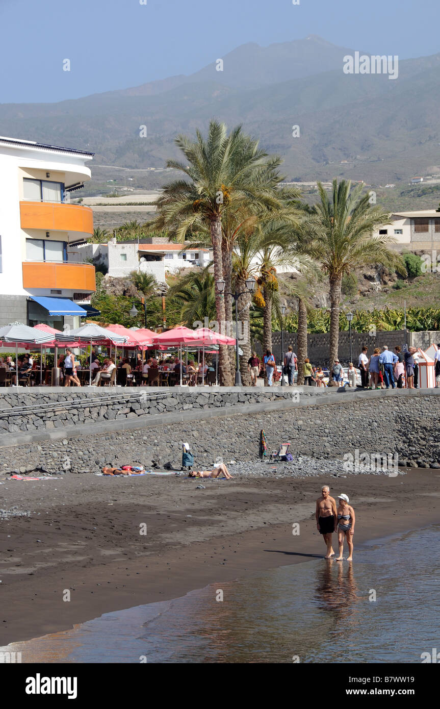 Der Uferpromenade und schwarzen sand Strand im Ferienort und Hafen von San Juan im Süden Teneriffa Kanarische Inseln Stockfoto