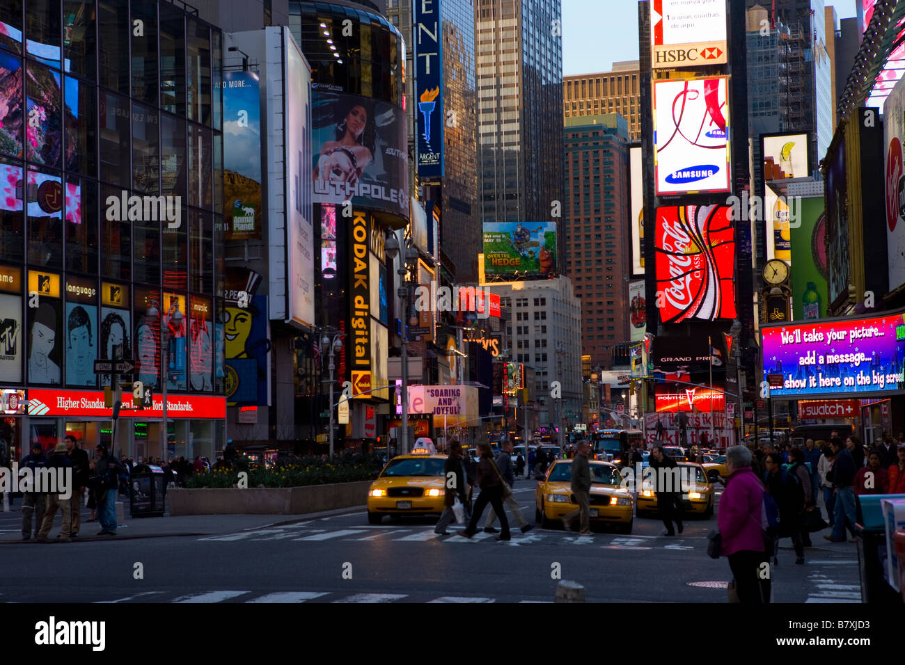 New York Times Square at dusk showing advertising and yellow cabs Stockfoto