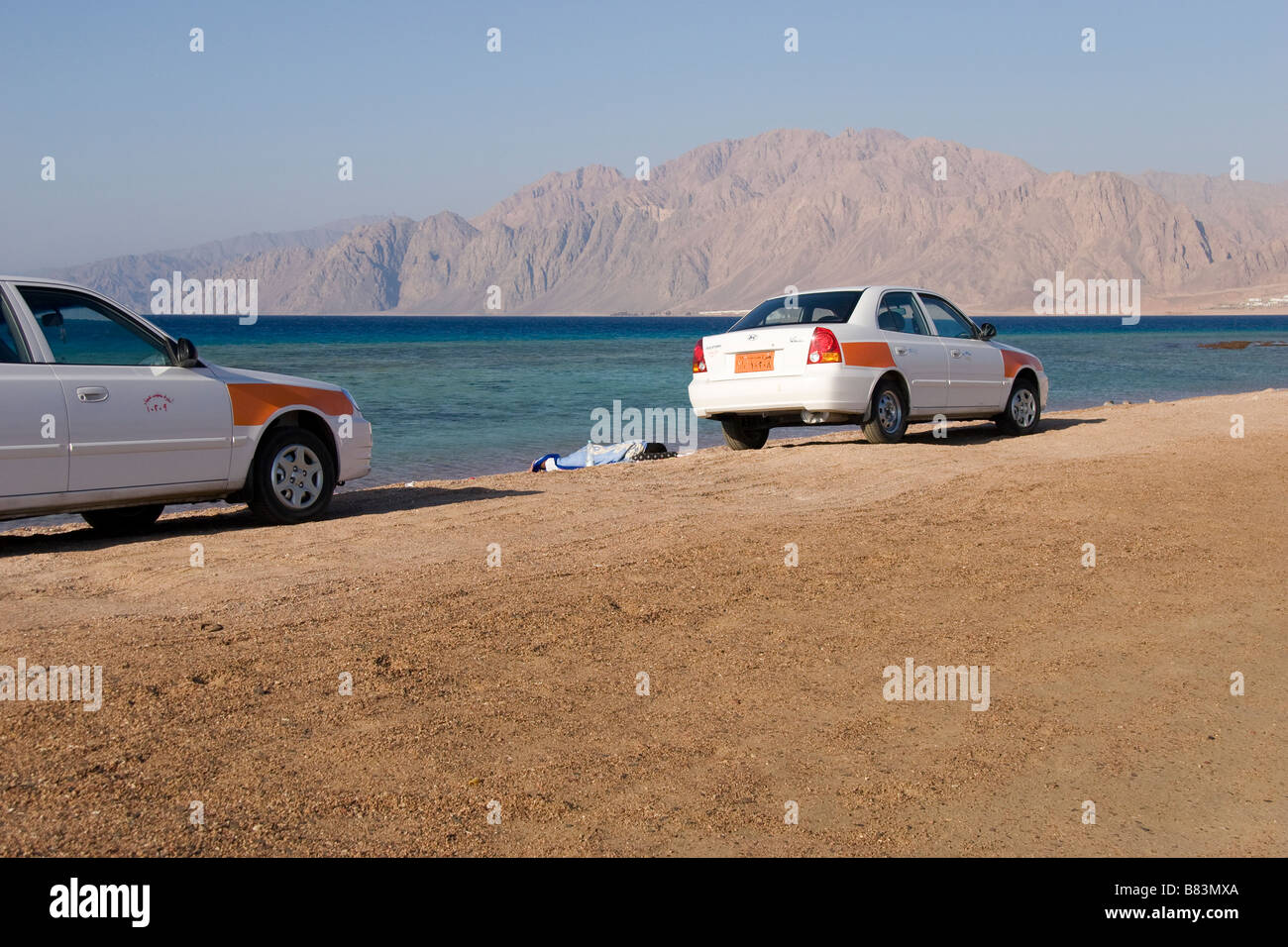 Lokalen Taxi Fahrer schlafen Nest zu ihren Autos geparkt auf dem Sand Spieß von Laguna Bay im Sinai Resort Dahab in Ägypten Stockfoto