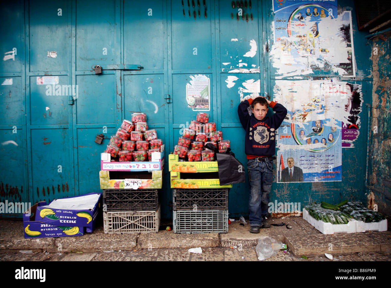 Ein palästinensisches Kind neben einem kleinen Früchten stand in der Altstadt von Jerusalem. Stockfoto