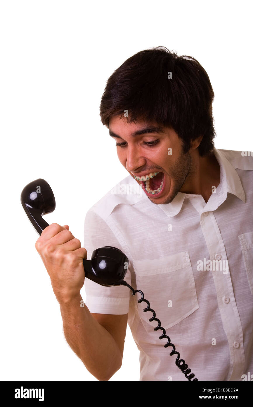 junge Männer, die schreiend auf den Telefonhörer Stockfoto